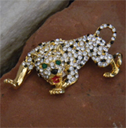 Exquisite cheetah vintage brooch with black enamel droplets amid the many rhinestones