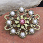 Bronze metal loop design brooch decorated with white pearls, yellow crystals and pink pearl