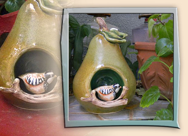 oversized pear sculpture with niche containing partridge bird
    