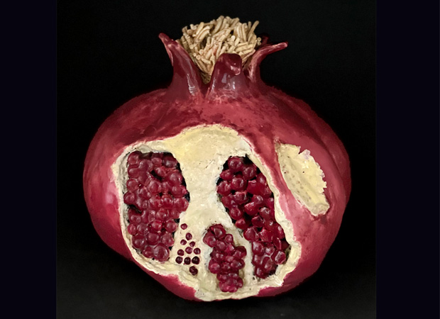 giant ripe pomegranate sculpture opened with fruit