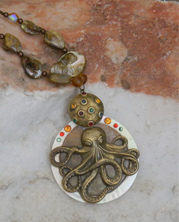 chunky designer necklace with bronze colored metal octopus pendant and shells