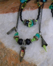 designer necklace with green glass beads and chain with industrial charms