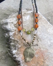designer necklace with metal leaf pendant with branch and crystals
