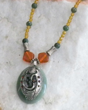 designer beaded necklace with mystery symbol and amber crystals