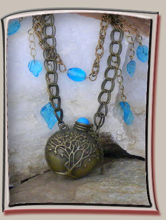 Vial Pendant with Tree Carving on Bronze Chain with Blue Glass leaf Accents