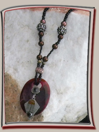 Industrial Charm on Burgundy Lucite Oval