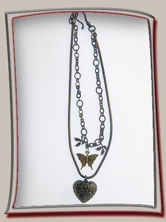 below heart pendant is dainty bronze butterfly and leaves for a layered necklace composition