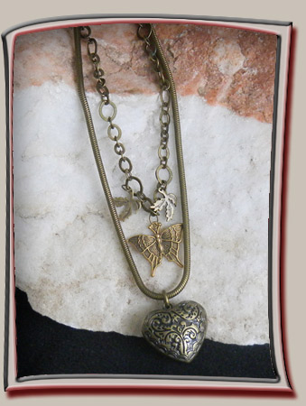 Designer necklace with Heart in bronze colored metal has deep texture