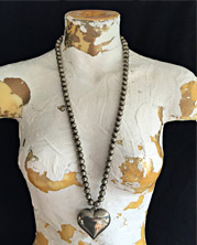 designer necklace with stone pendant, accented with a collection of different shades of green