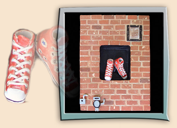 street scene with brick wall and red sneakers